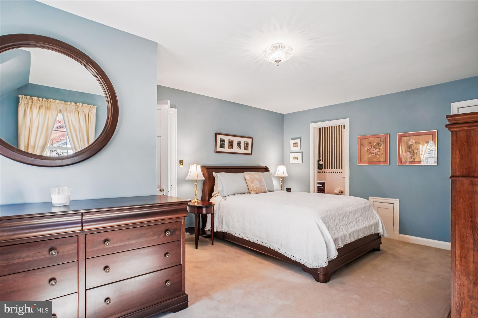 5103 Fairglen Lane Chevy Chase, MD 20815 - Photo 18 of 41 a bedroom with a bed and a painting on the wall