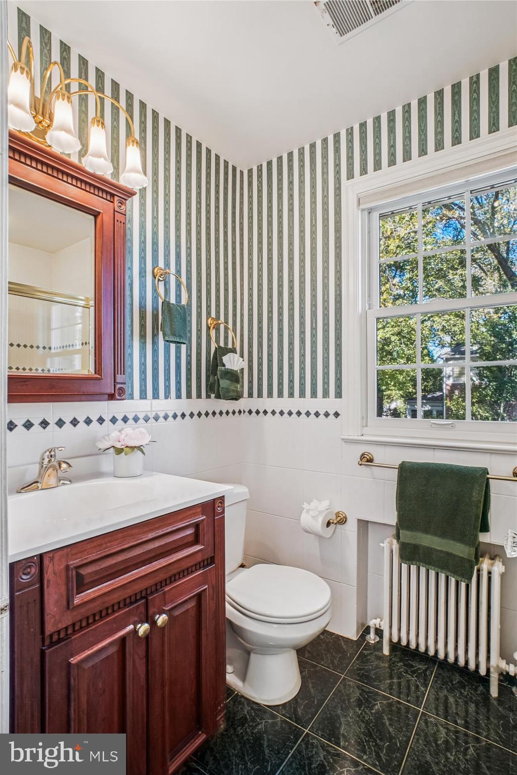 5103 Fairglen Lane Chevy Chase, MD 20815 - Photo 19 of 41 a bathroom with a toilet a sink and a window