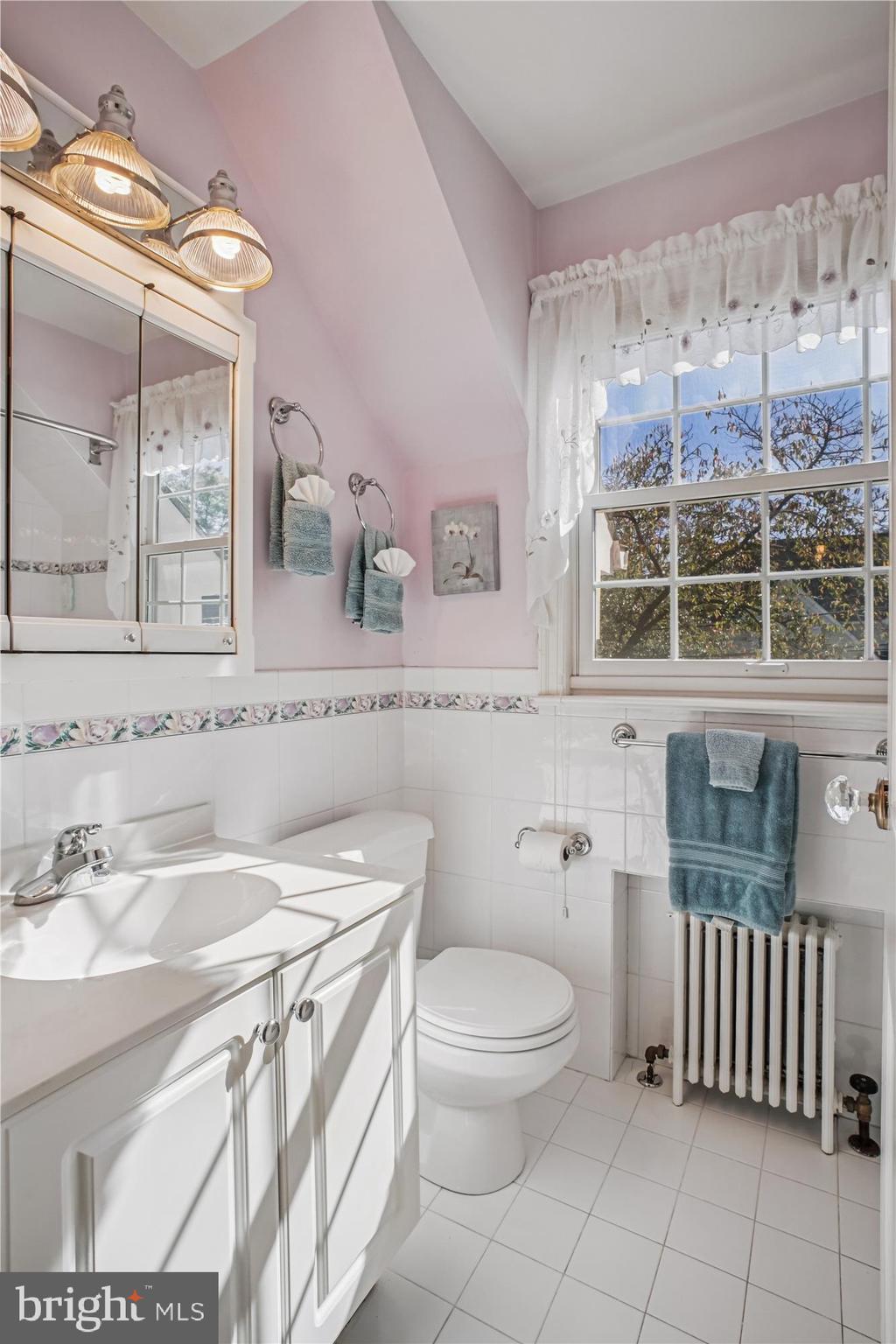 5103 Fairglen Lane Chevy Chase, MD 20815 - Photo 22 of 41 a bathroom with a sink a toilet and mirror