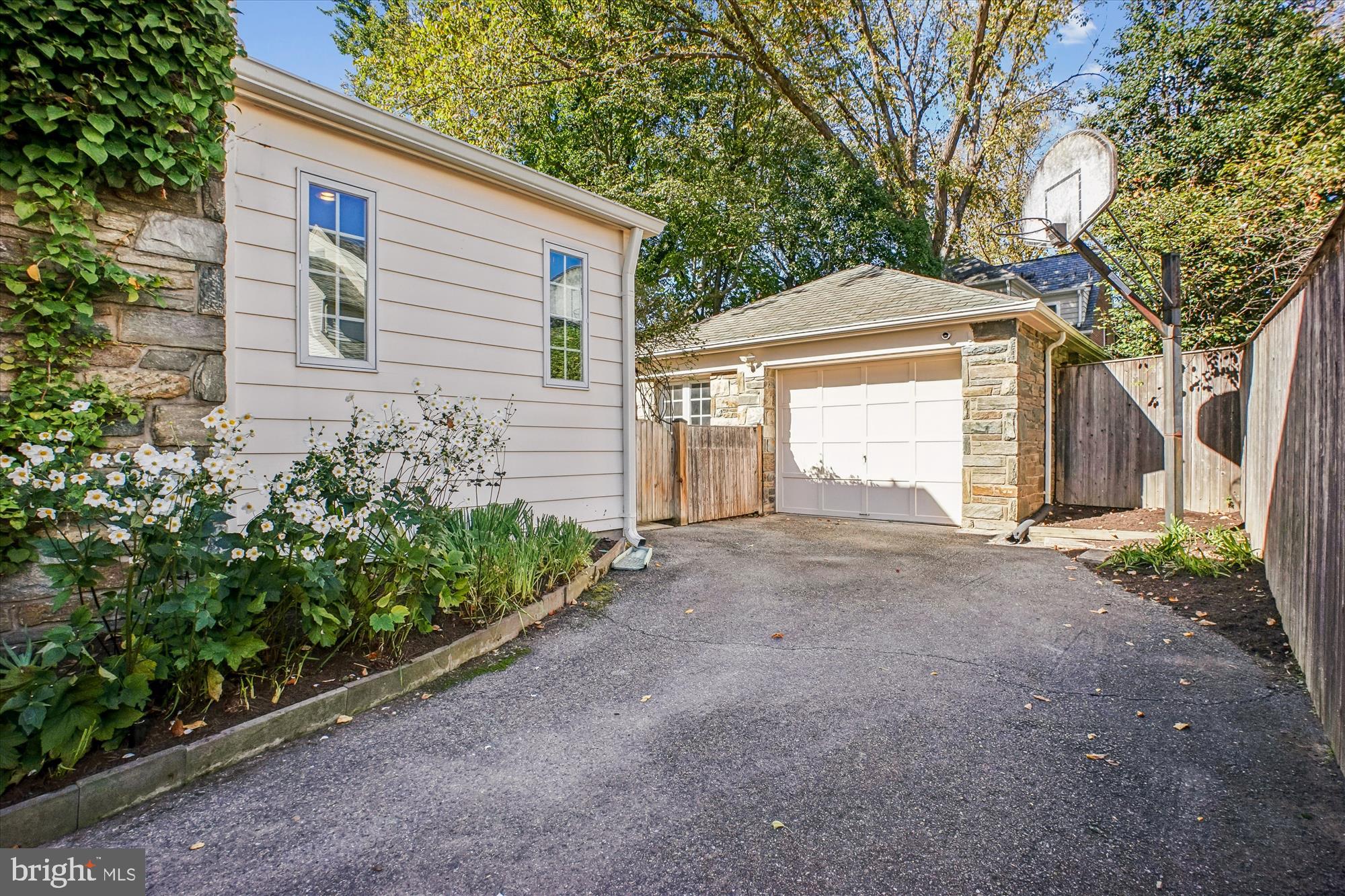 5103 Fairglen Lane Chevy Chase, MD 20815 - Photo 31 of 41 a front view of a house with a yard and garage