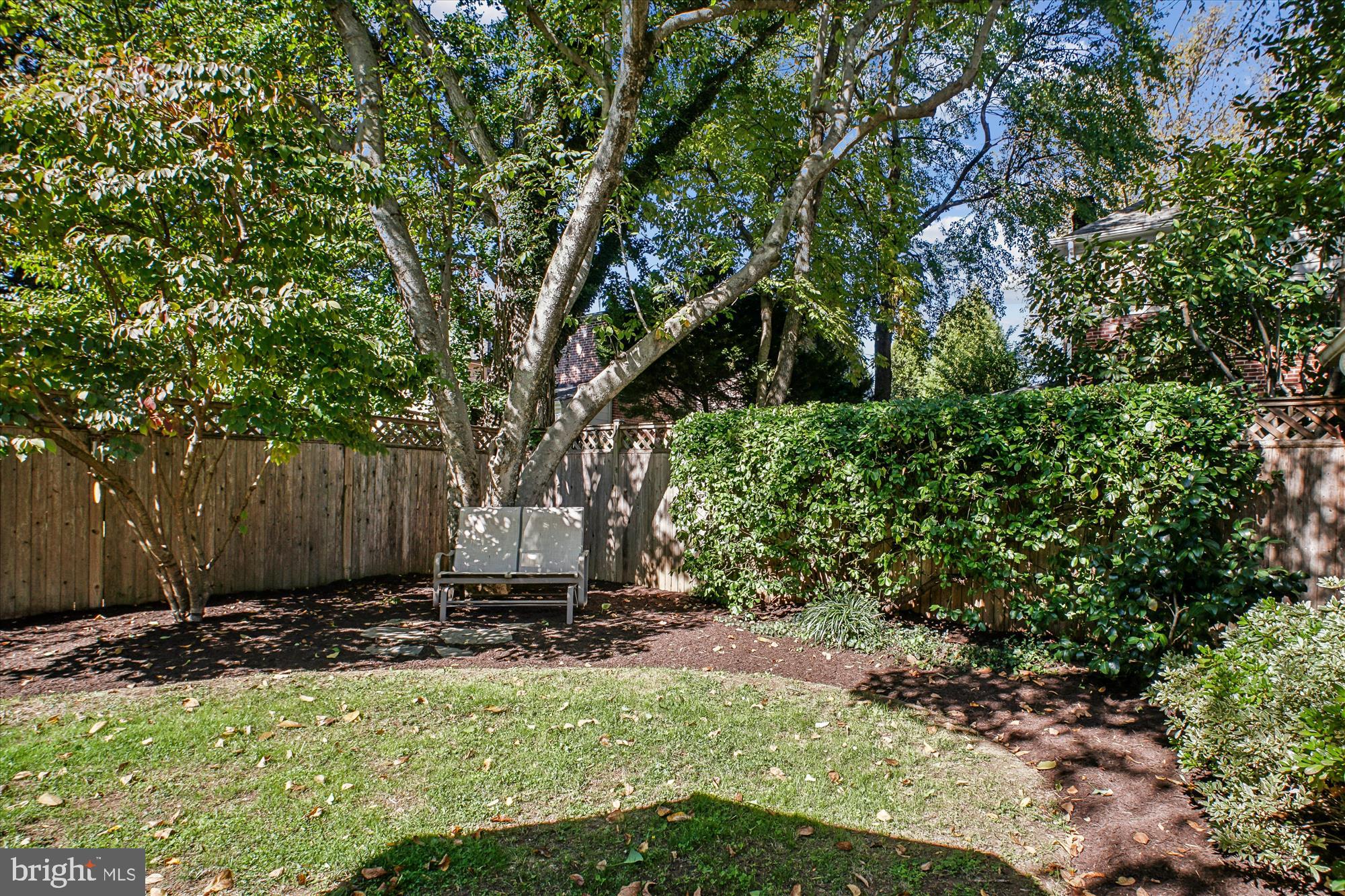 5103 Fairglen Lane Chevy Chase, MD 20815 - Photo 34 of 41 a view of a backyard with large trees and wooden fence