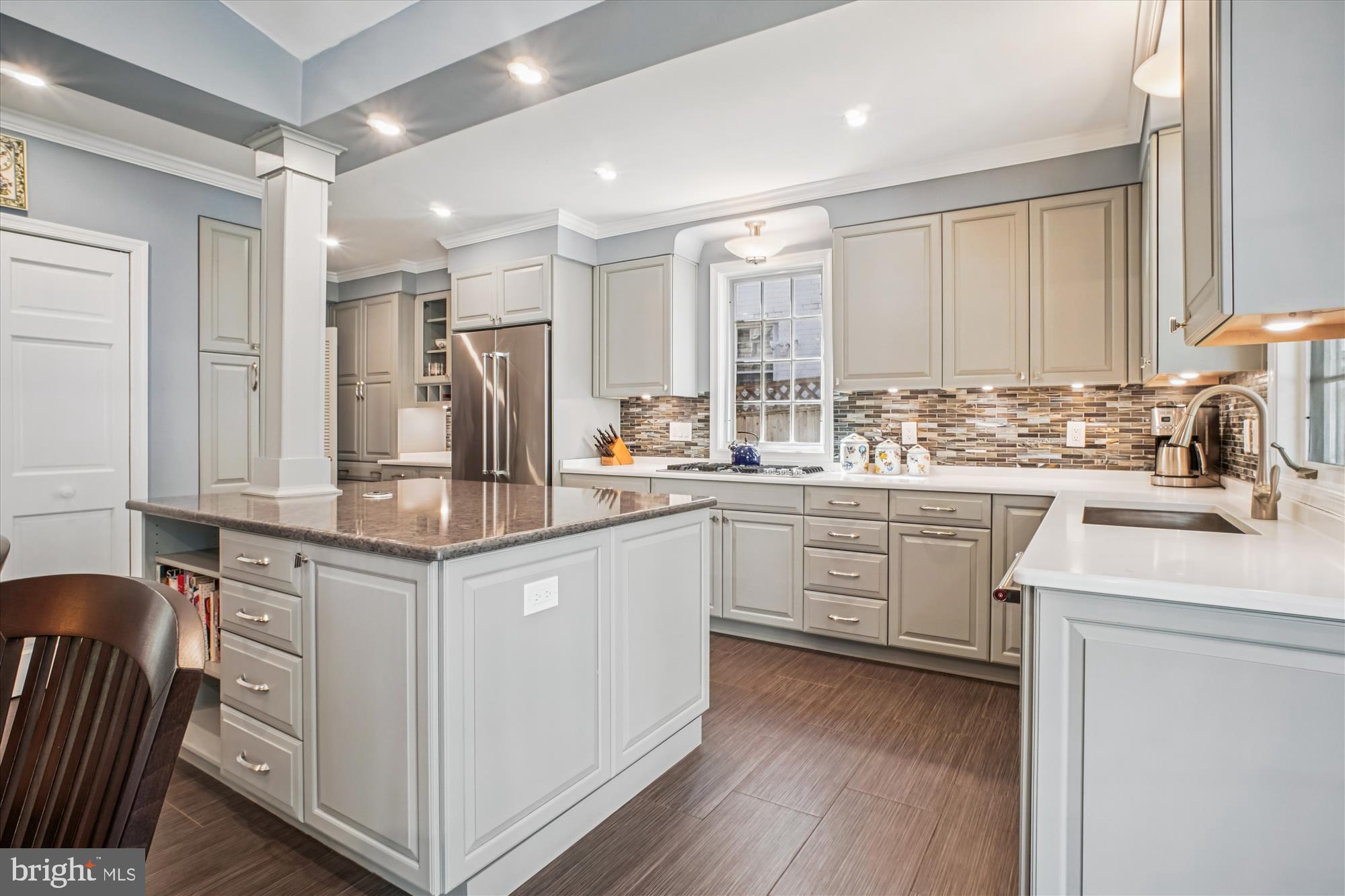 5103 Fairglen Lane Chevy Chase, MD 20815 - Photo 8 of 41 a kitchen with a sink cabinets stainless steel appliances and a window