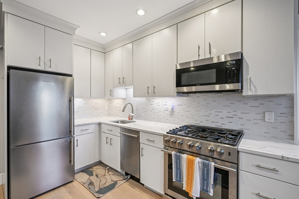 600 Shirley Street, Unit 4 Winthrop, MA 02152 - Photo 12 of 29 a kitchen with stainless steel appliances a stove microwave and refrigerator
