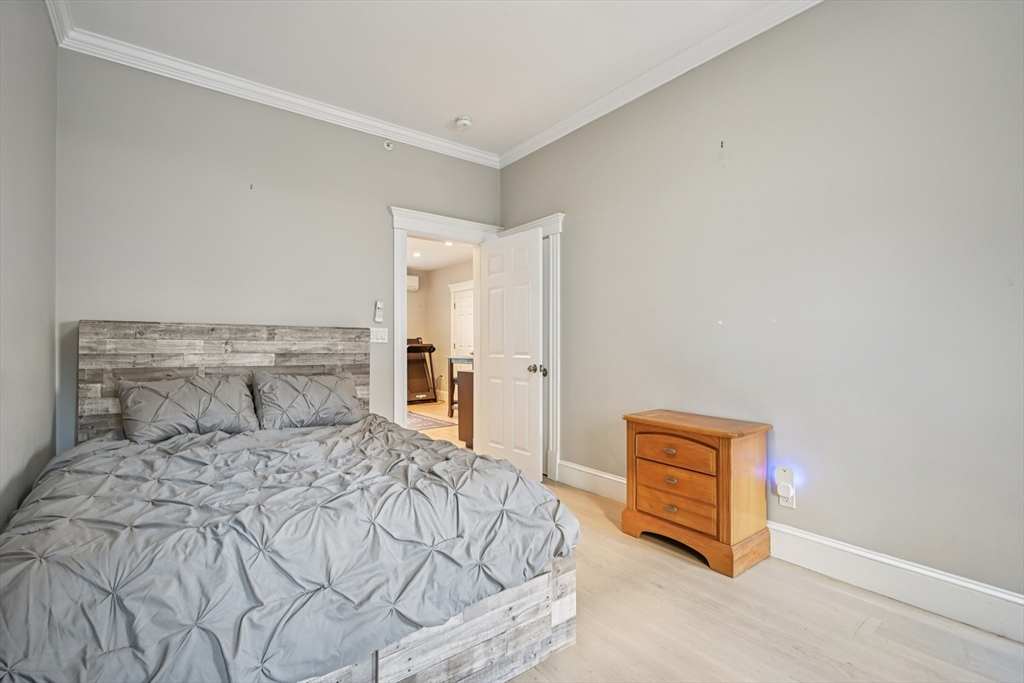 600 Shirley Street, Unit 4 Winthrop, MA 02152 - Photo 19 of 29 a bedroom with a bed and a painting on the wall