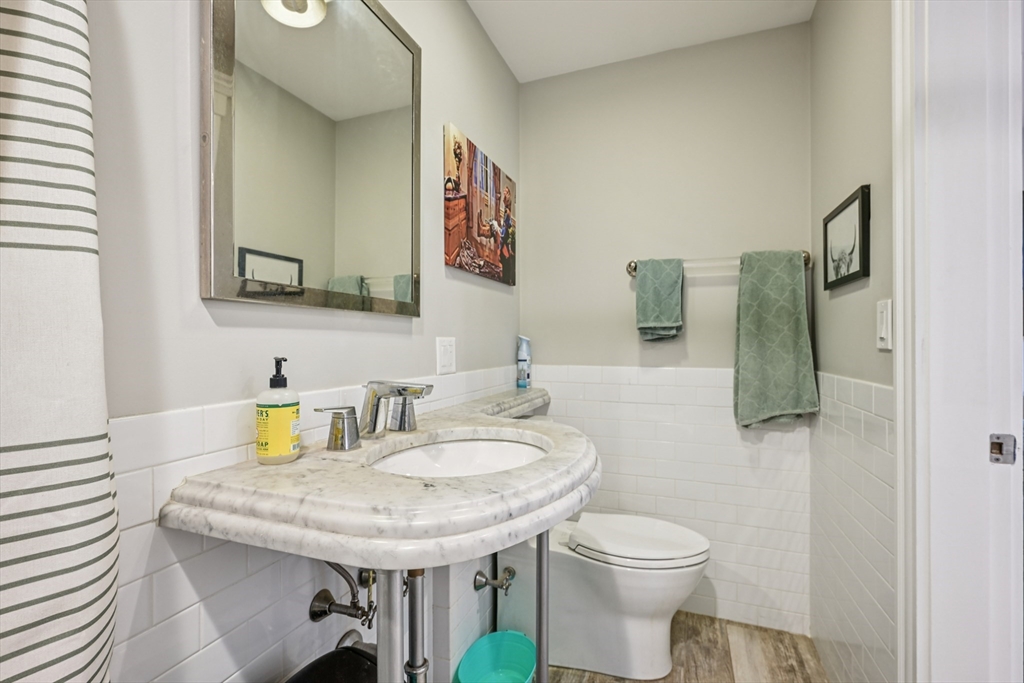 600 Shirley Street, Unit 4 Winthrop, MA 02152 - Photo 22 of 29 a bathroom with a granite countertop sink and a toilet