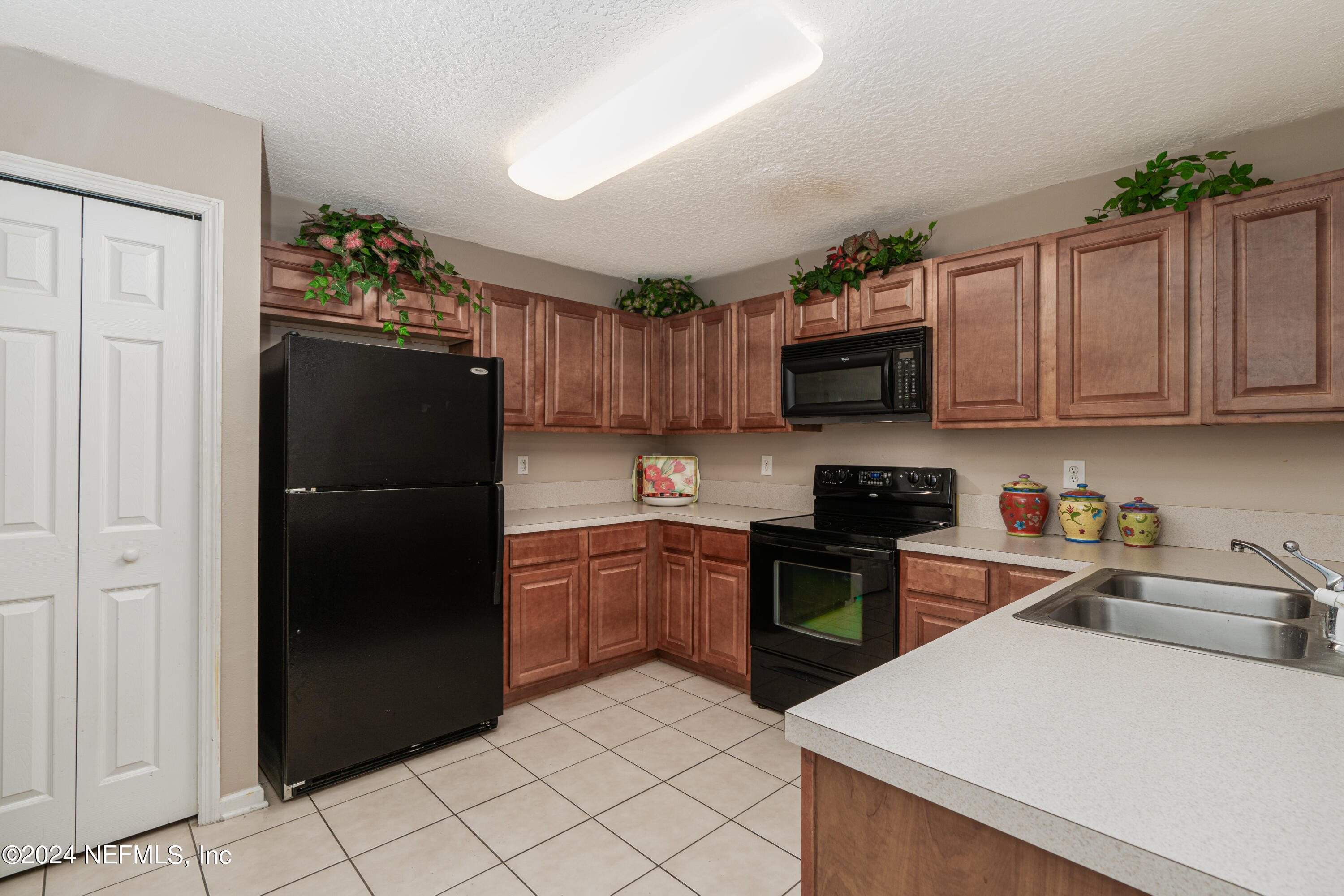 7920 Merrill Road, Unit 709 Jacksonville, FL 32277 - Photo 3 of 25 a kitchen with a refrigerator sink and microwave