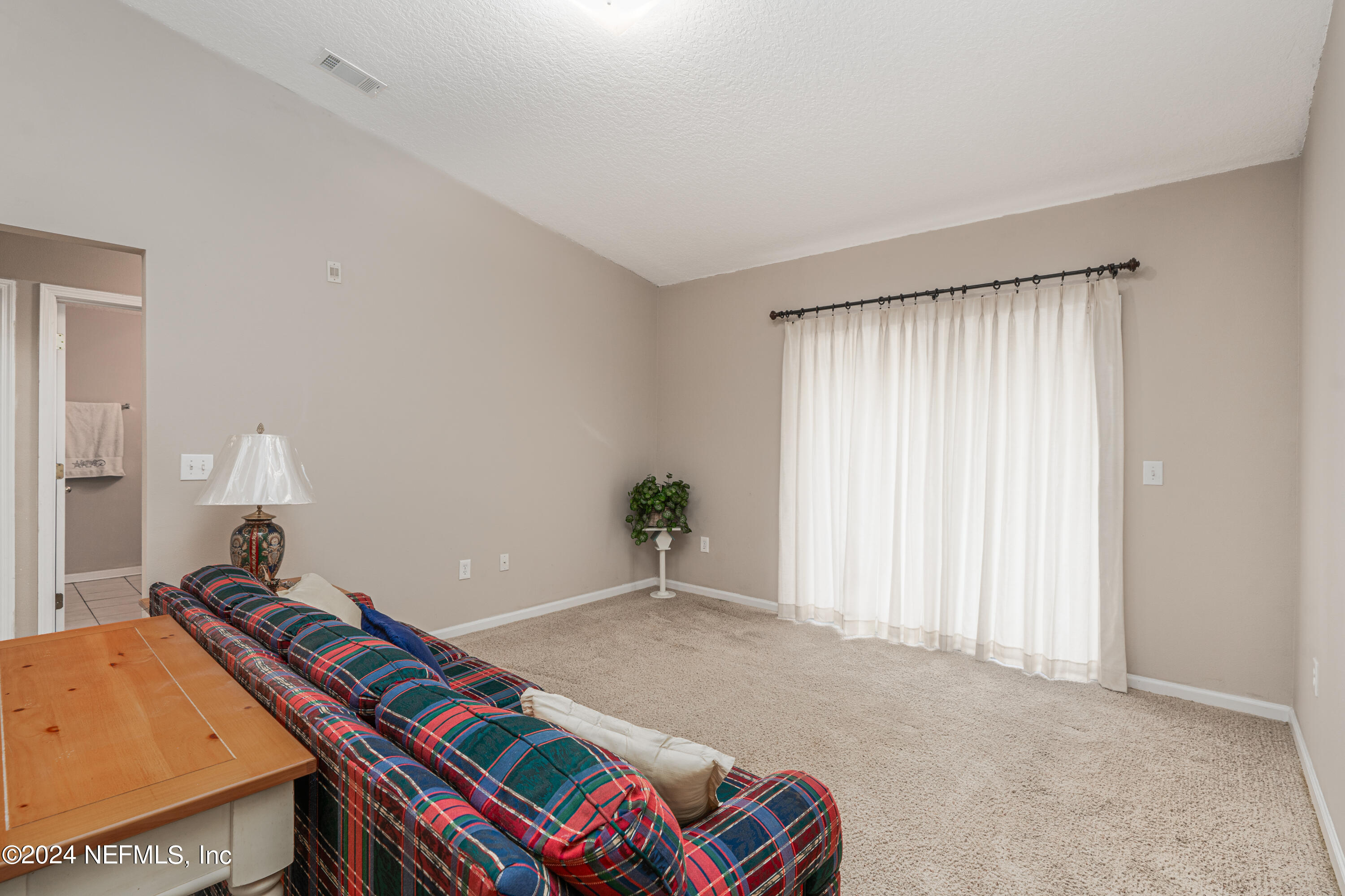 7920 Merrill Road, Unit 709 Jacksonville, FL 32277 - Photo 8 of 25 a room with a bed and a window
