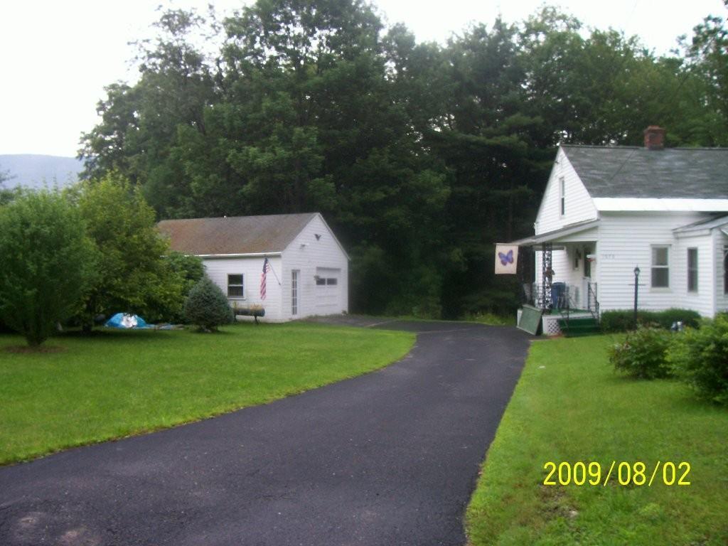 1070 Middle Road Clarksburg, MA 01247 - Photo 3 of 8 a front view of a house with garden