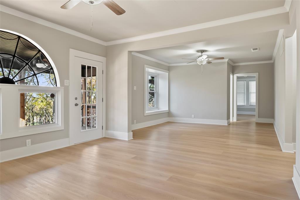 308 Country Club Road Argyle, TX 76226 - Photo 11 of 37 a view of an empty room with window and wooden floor