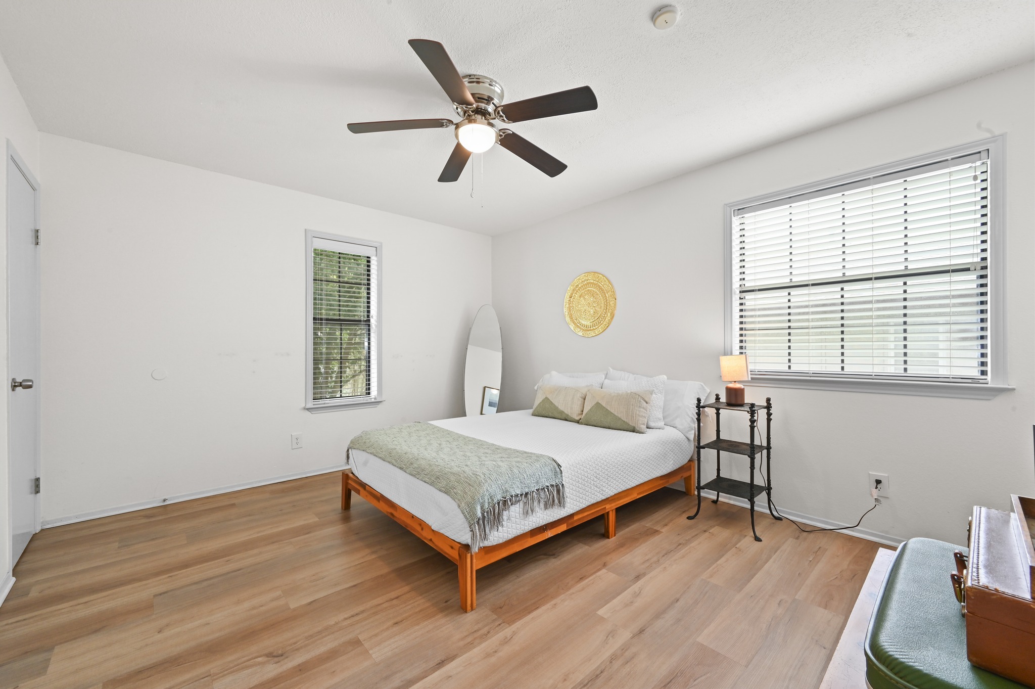 6805 Rearden Road Austin, TX 78745 - Photo 13 of 26 Hardwood floors and generous natural light create an inviting atmosphere in this comfortable bedroom.