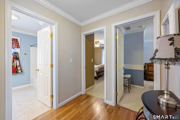 a bathroom with a granite countertop double vanity sink a mirror and a bathtub
