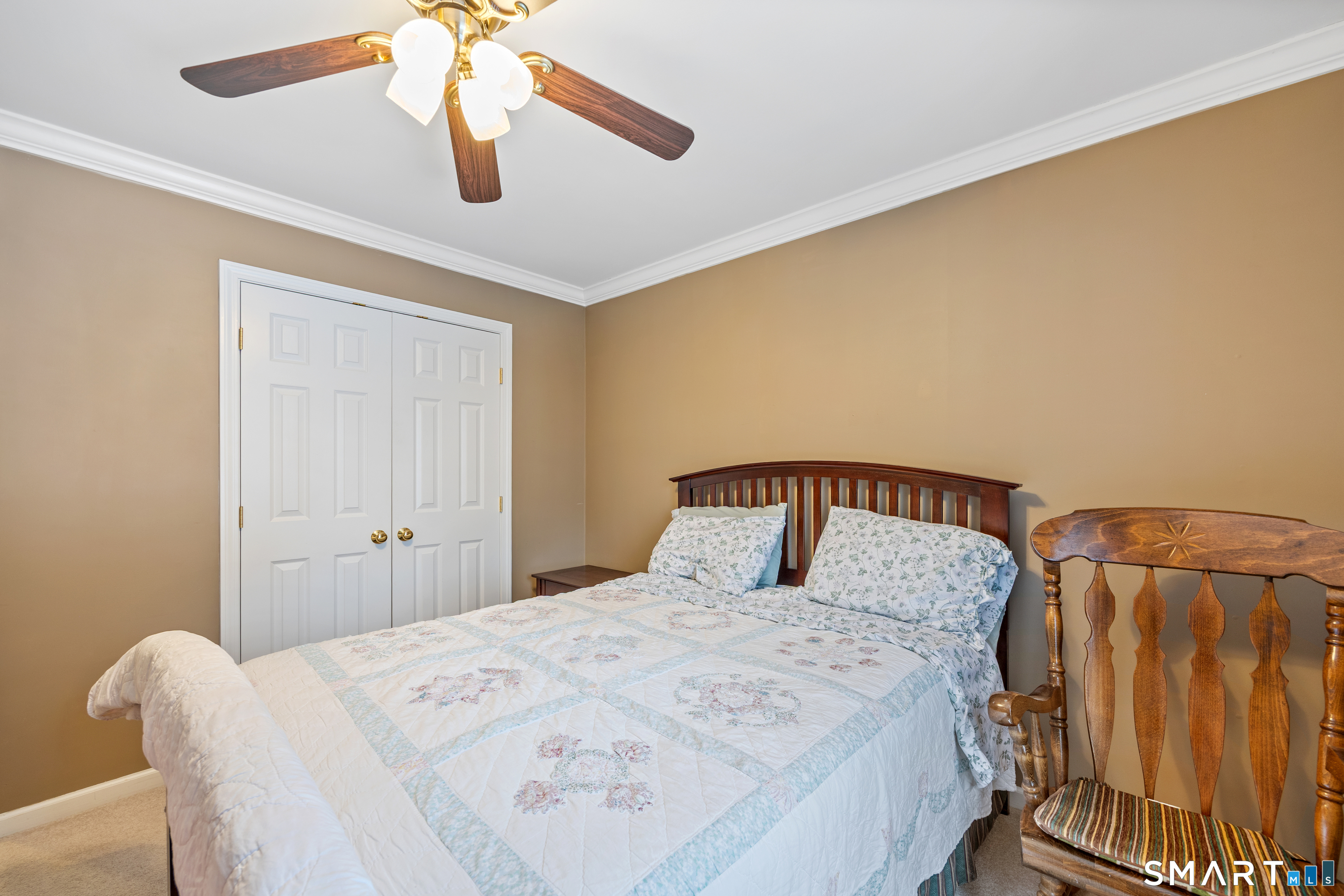 3 Ellen Lane Thomaston, CT 06787 - Photo 27 of 40 a bedroom with a bed and a chandelier