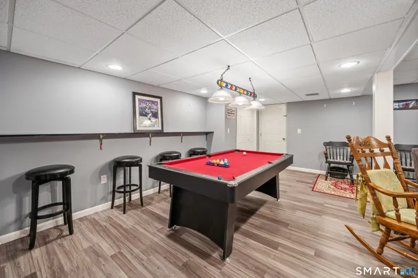 a view of a workspace with furniture and a rug