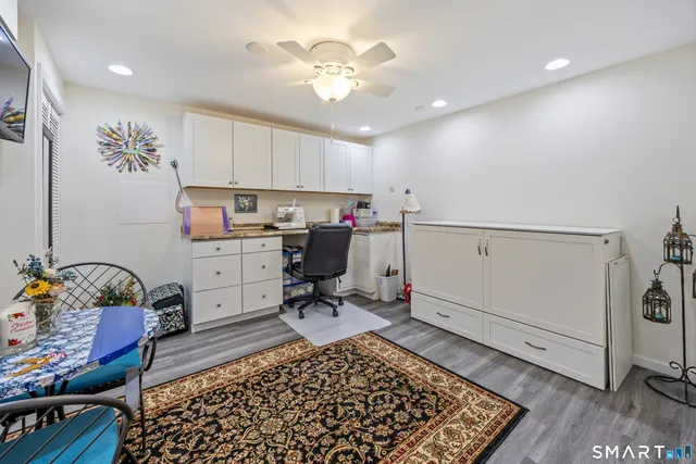 a bathroom with a toilet sink vanity and mirror