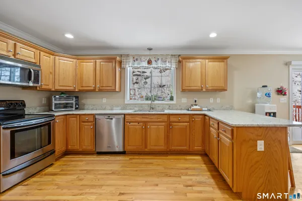 a kitchen with stainless steel appliances granite countertop a sink and cabinets