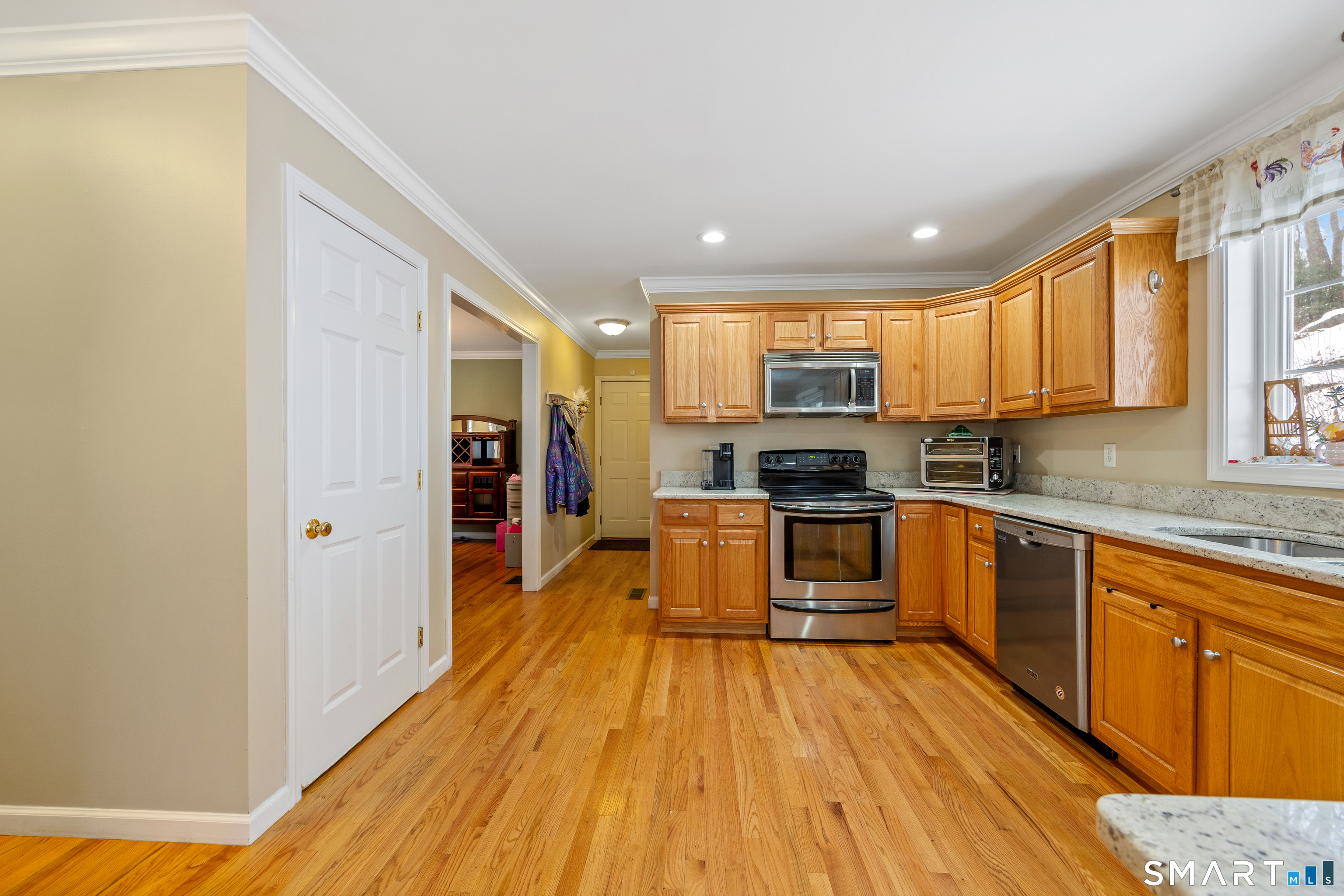 3 Ellen Lane Thomaston, CT 06787 - Photo 10 of 40 a kitchen with stainless steel appliances granite countertop a stove top oven a sink dishwasher and a refrigerator with wooden floor