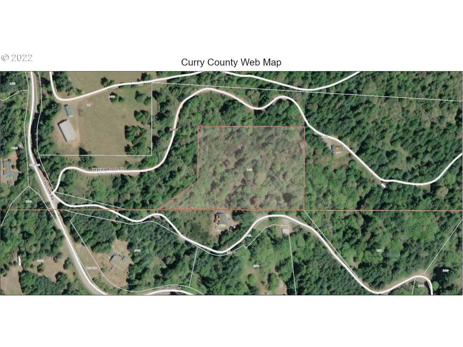 Skyview, Unit 101 Gold Beach, OR 97444 - Photo 12 of 16 a black white house with a forest