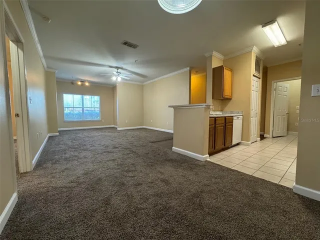 a view of a kitchen with a sink and a refrigerator