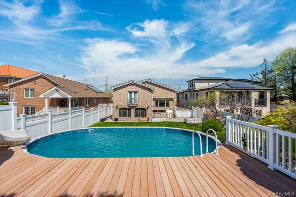 a view of a house with pool and chairs