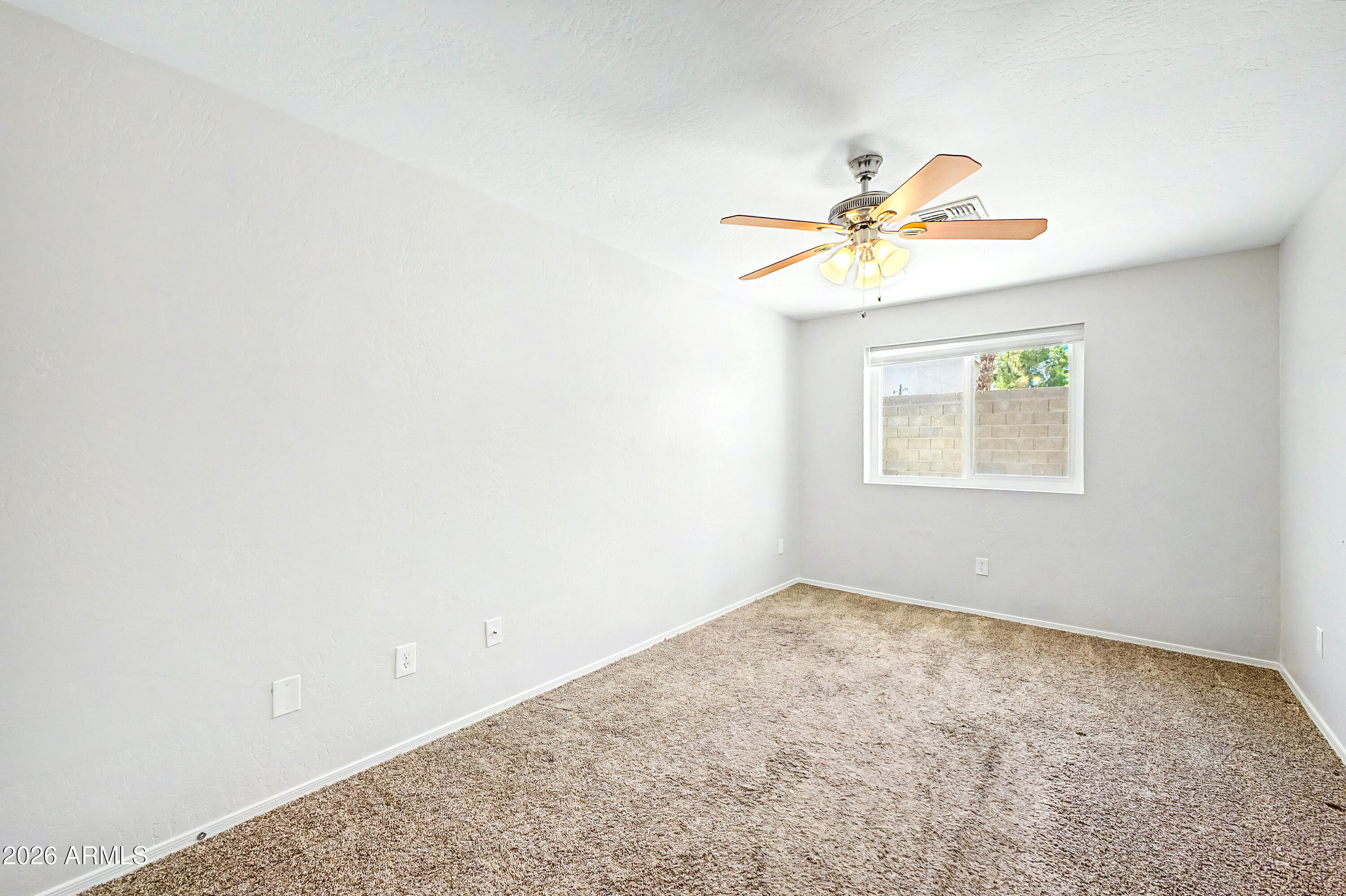 3134 East McKellips Road, Unit 221 Mesa, AZ 85213 - Photo 18 of 29 an empty room with a window and a ceiling fan