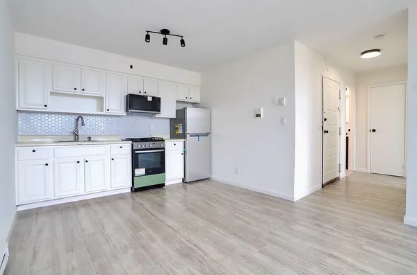 a view of an empty room and wooden floor