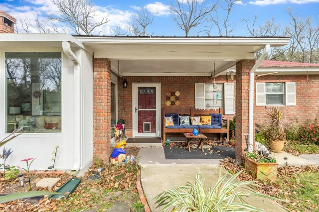 a bathroom with a granite countertop toilet sink and mirror