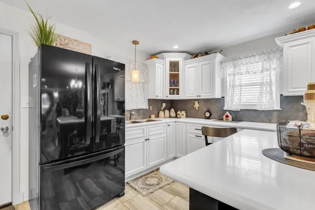 a backyard of a house with table and chairs