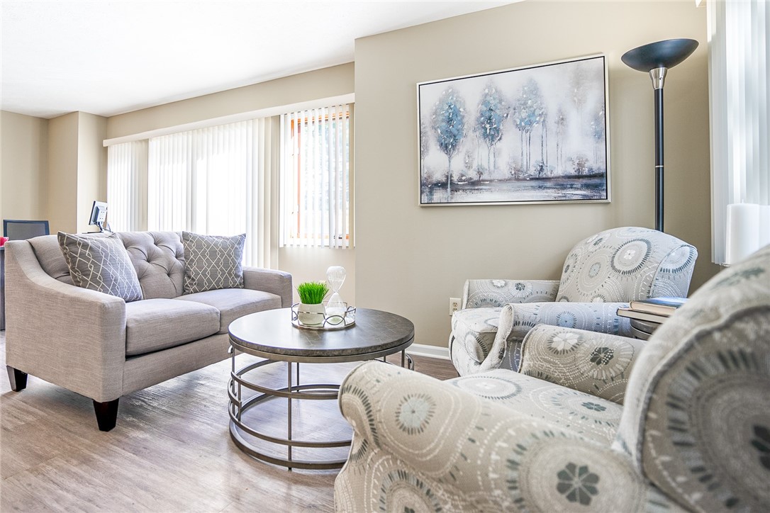 32 Riverferry Way Rochester, NY 14608 - Photo 2 of 10 Typical Great Room with faux wood floors (view sho