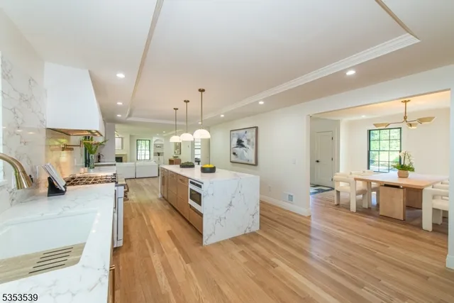 a large white kitchen with lots of counter space and furniture