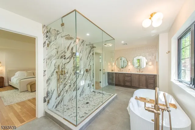 a bathroom with a tub sink and mirror