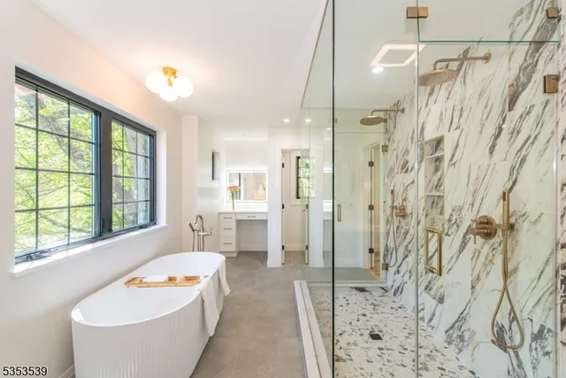 a bathroom with a tub sink and mirror