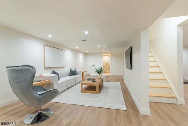 a view of a room with wooden floor and furniture