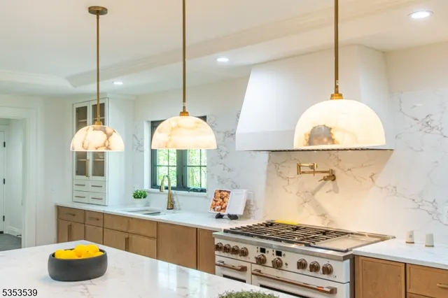 a kitchen with a stove a sink and a wooden floor