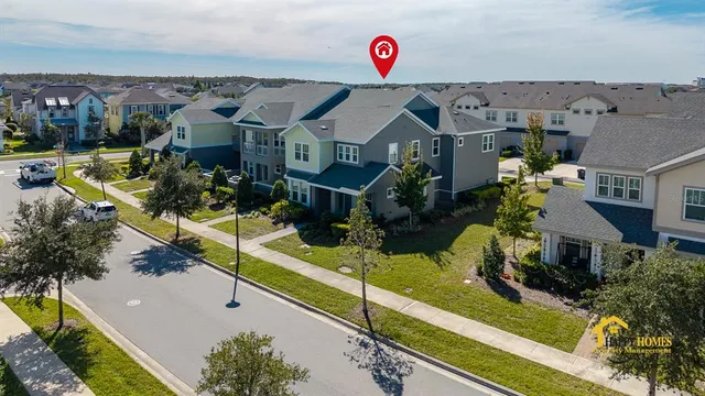 an aerial view of residential houses with outdoor space