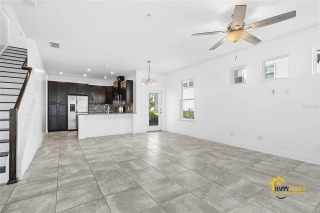 a view of a kitchen with a sink and a chandelier fan