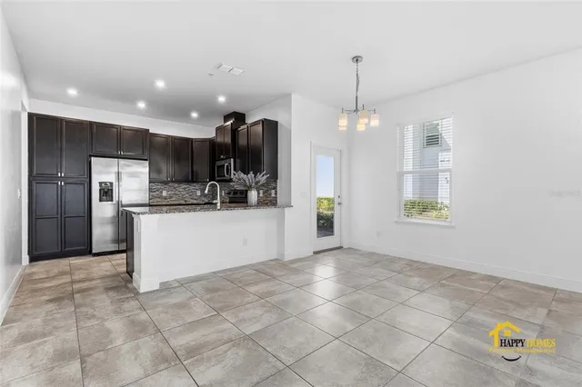 a view of kitchen with refrigerator and window