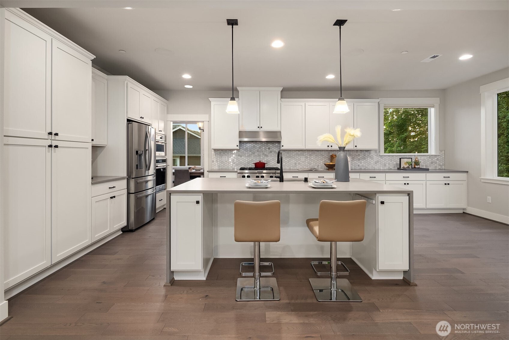 9934 Northeast 162nd Street Bothell, WA 98011 - Photo 12 of 40 a kitchen with stainless steel appliances kitchen island a refrigerator a stove a sink and chairs