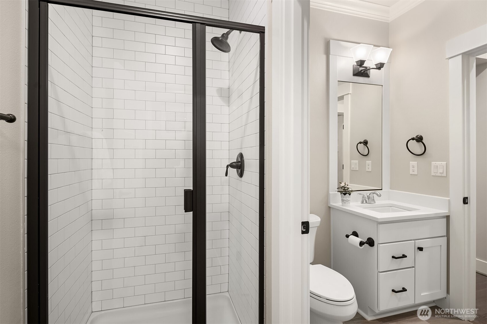 9934 Northeast 162nd Street Bothell, WA 98011 - Photo 18 of 40 a bathroom with a granite countertop sink toilet a shower a mirror and