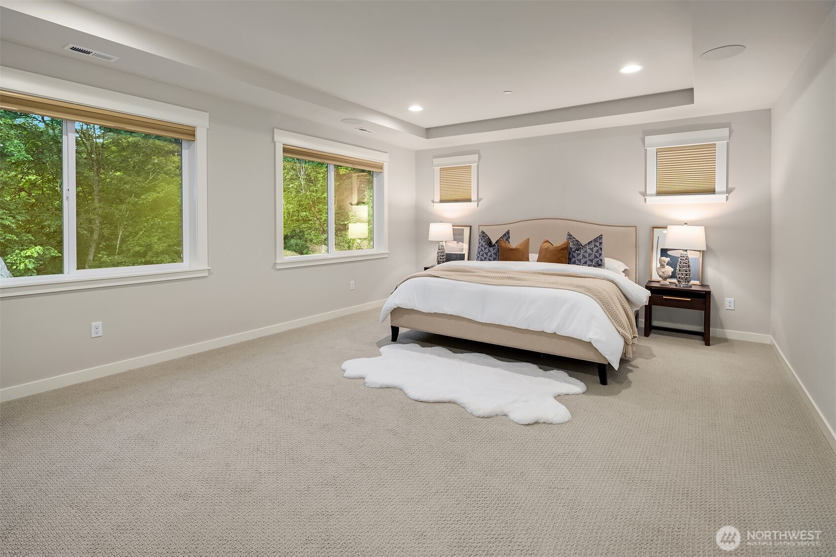 9934 Northeast 162nd Street Bothell, WA 98011 - Photo 23 of 40 a spacious bedroom with a bed and a large window