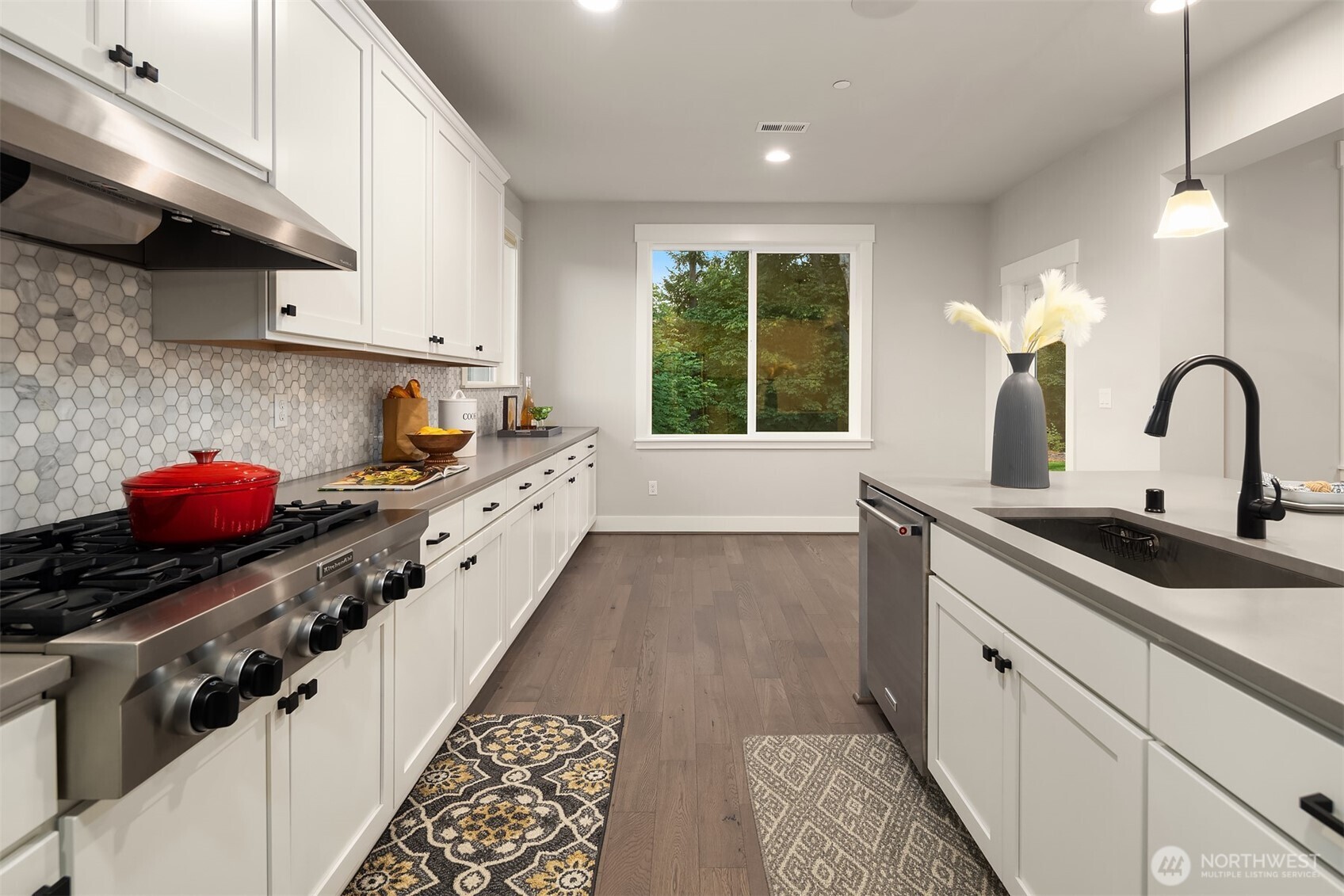 9934 Northeast 162nd Street Bothell, WA 98011 - Photo 9 of 40 a kitchen with a sink stove and cabinets