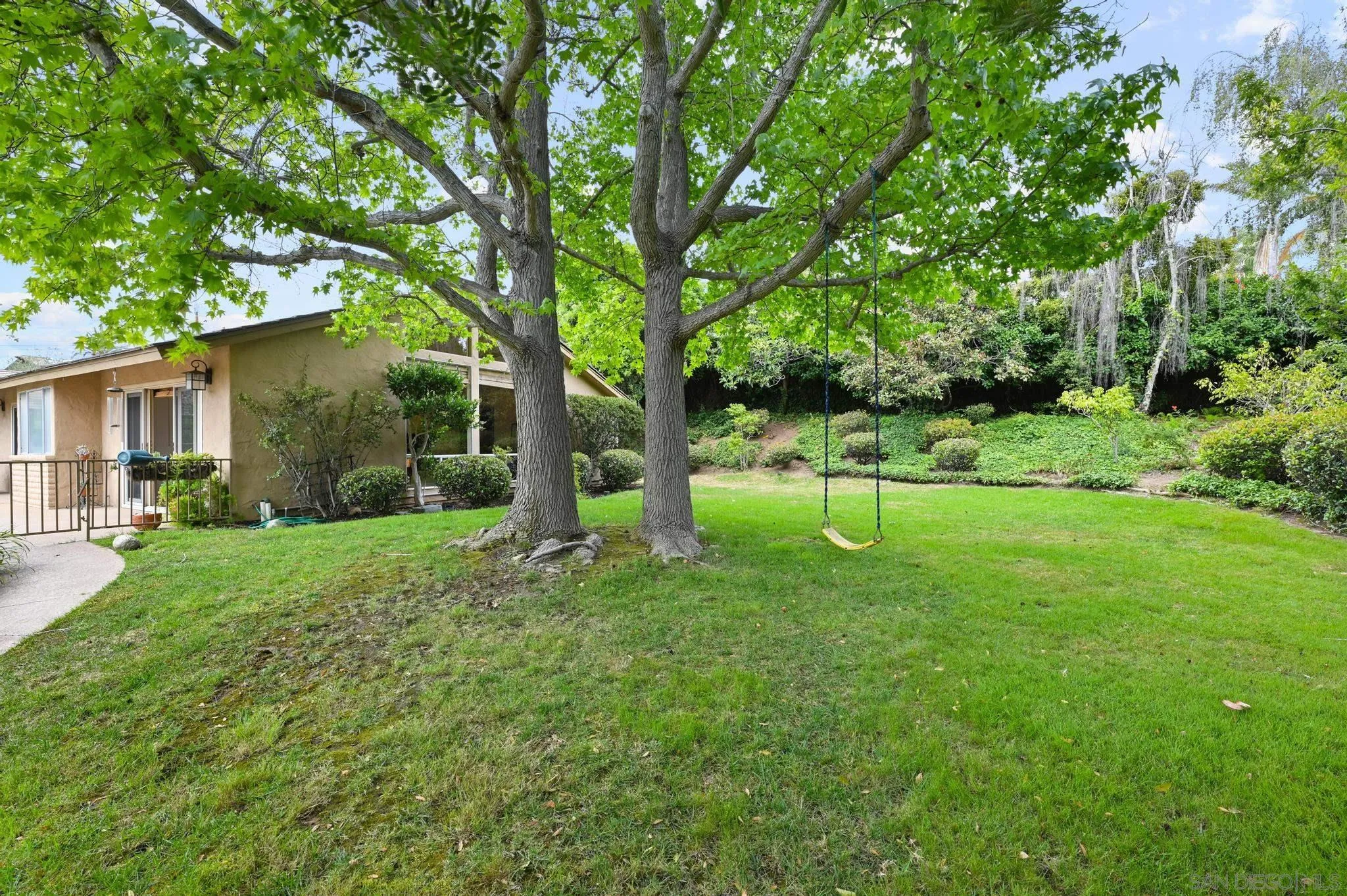 4200 Clearview Drive Carlsbad, CA 92008 - Photo 66 of 73 a backyard of a house with plants and large tree