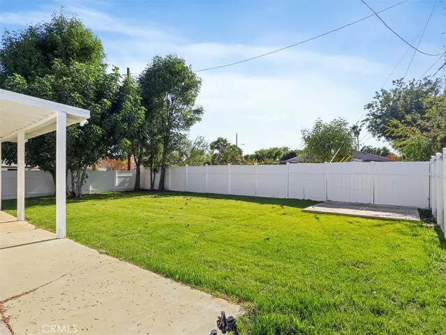 a view of a backyard with a garden and trees