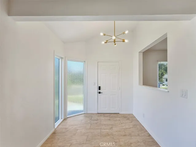 an empty room with fan and entrance