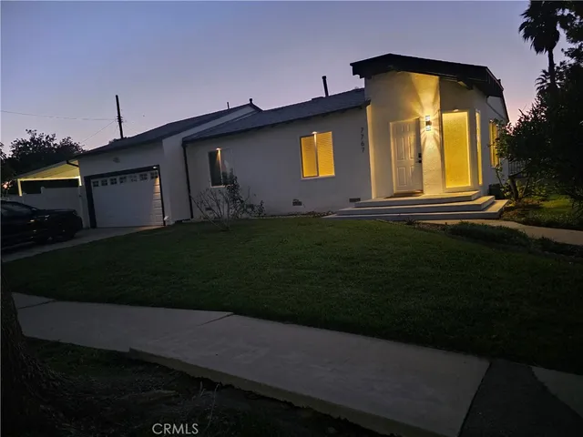 a front view of a house with a garden