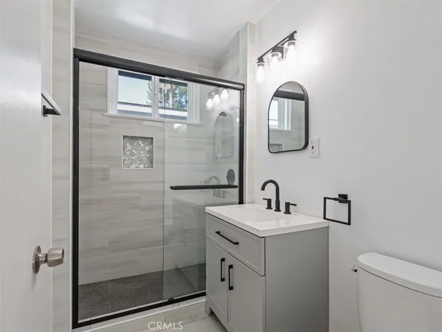 a bathroom with a sink a mirror and shower