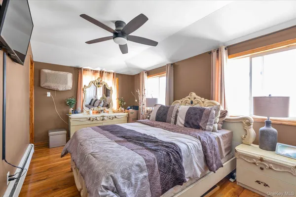 a bedroom with a large bed and a large window