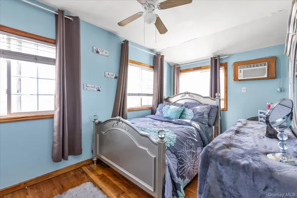 a bedroom with two beds and windows