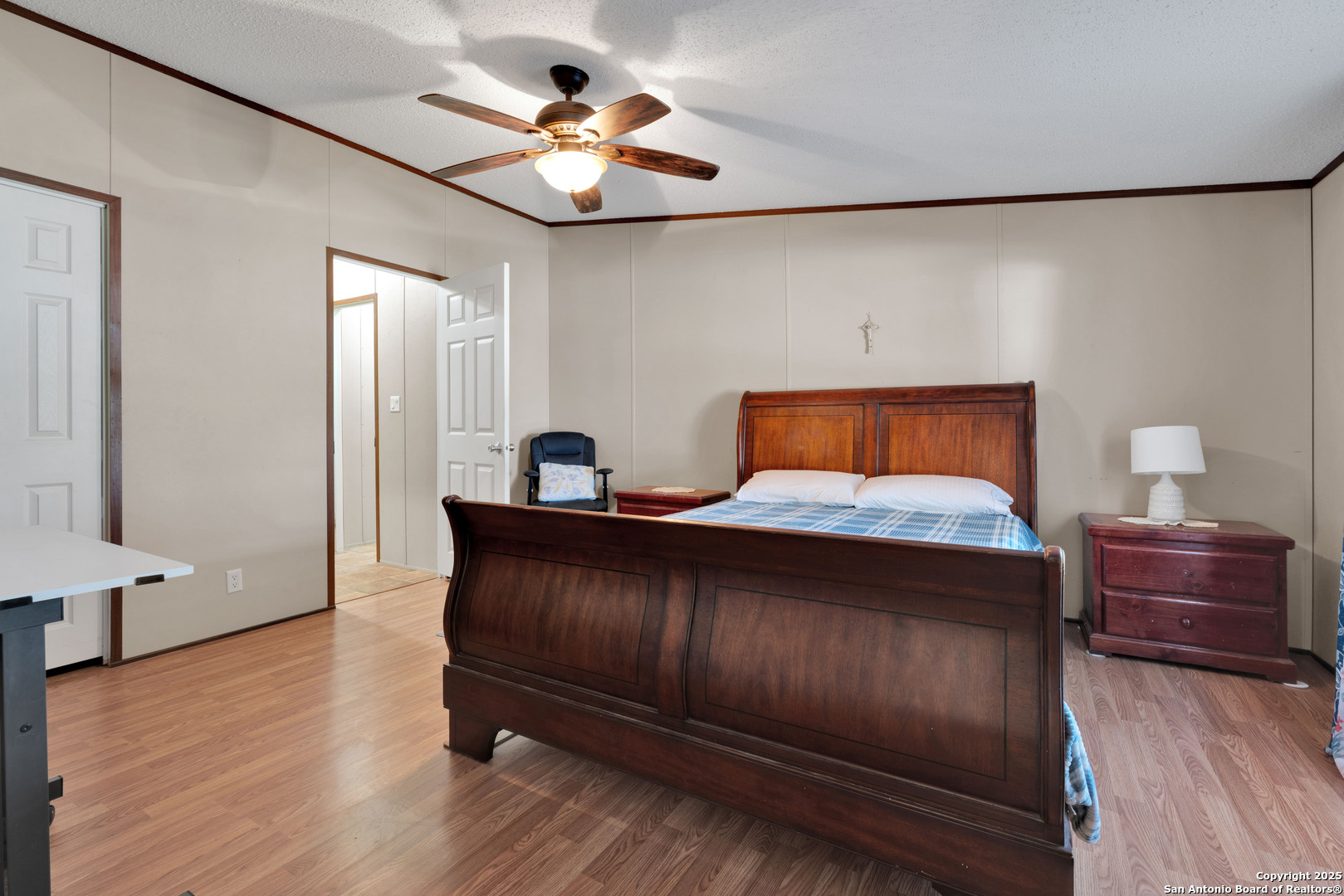 7176 Burshard Road San Antonio, TX 78263 - Photo 11 of 20 a bedroom with a bed and wooden floor