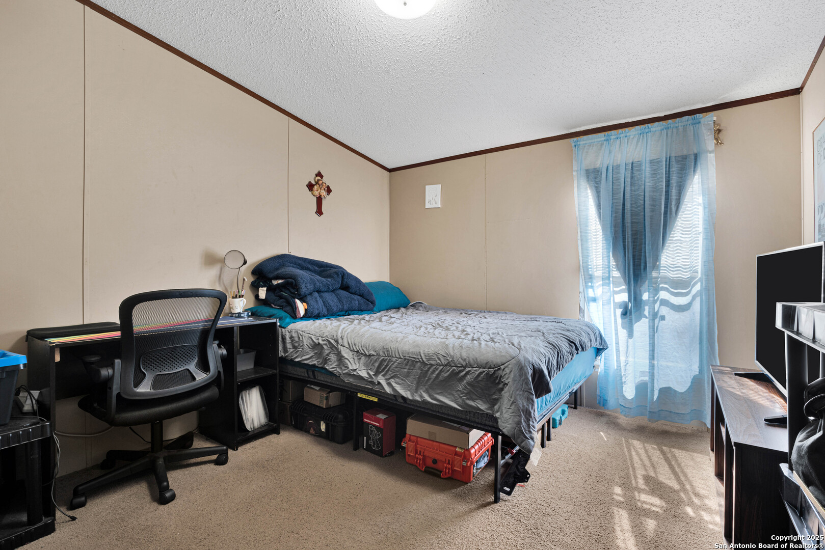 7176 Burshard Road San Antonio, TX 78263 - Photo 14 of 20 a bedroom with a bed and a chandelier