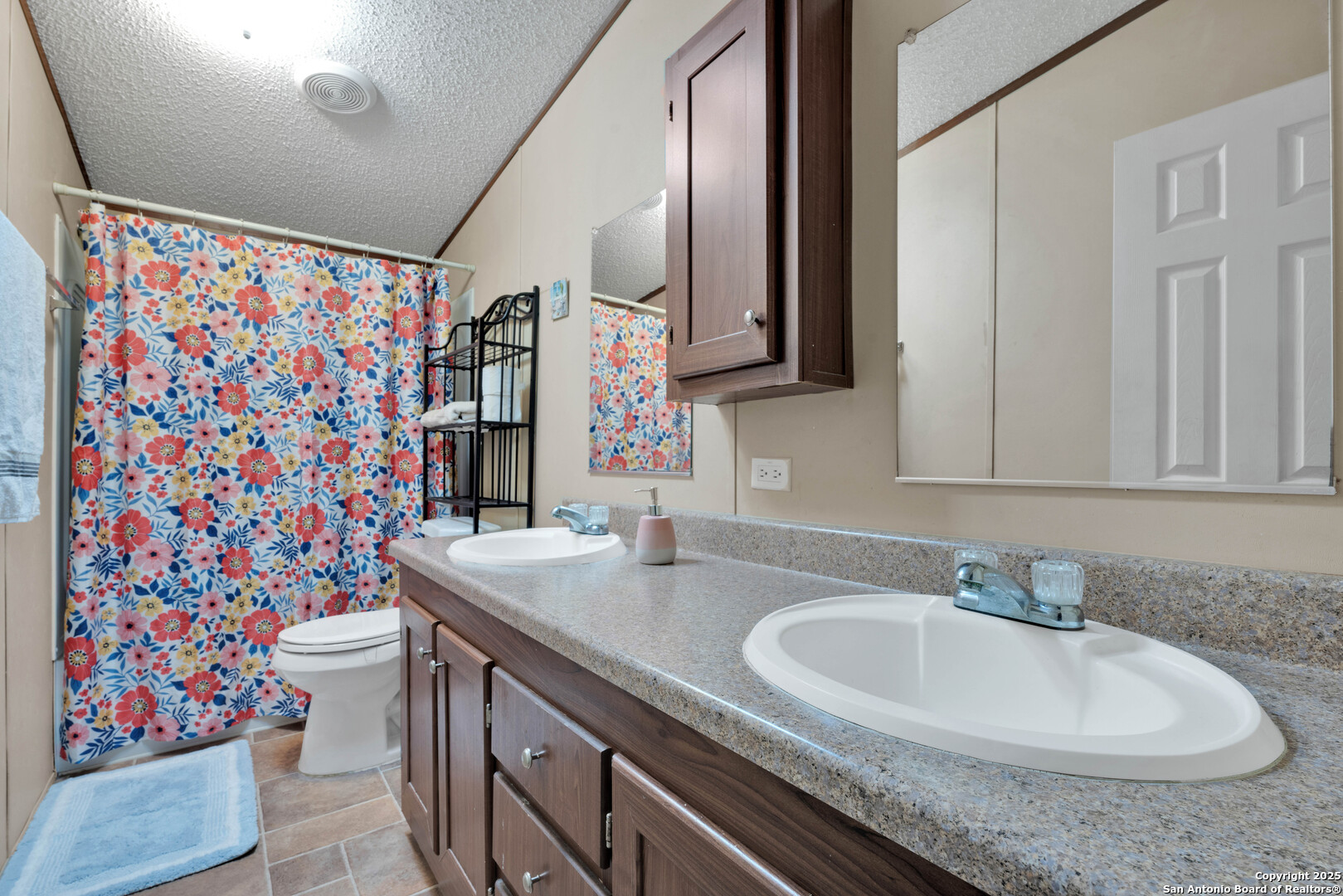 7176 Burshard Road San Antonio, TX 78263 - Photo 15 of 20 a bathroom with a sink and a mirror